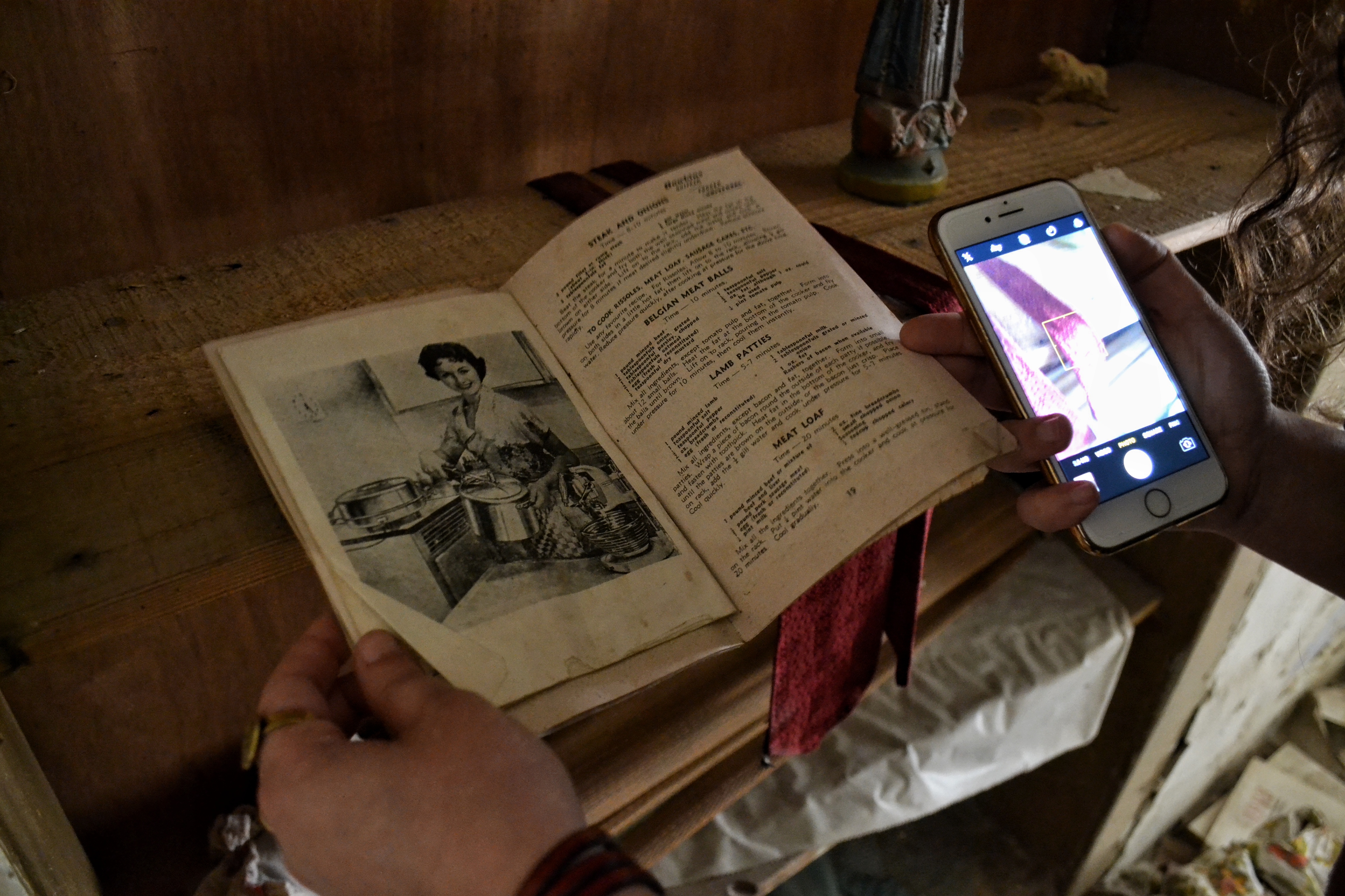 Mezher examines an old recipe book from the 1950s